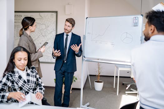 Business team discussing strategies at a whiteboard in a contemporary office setting.